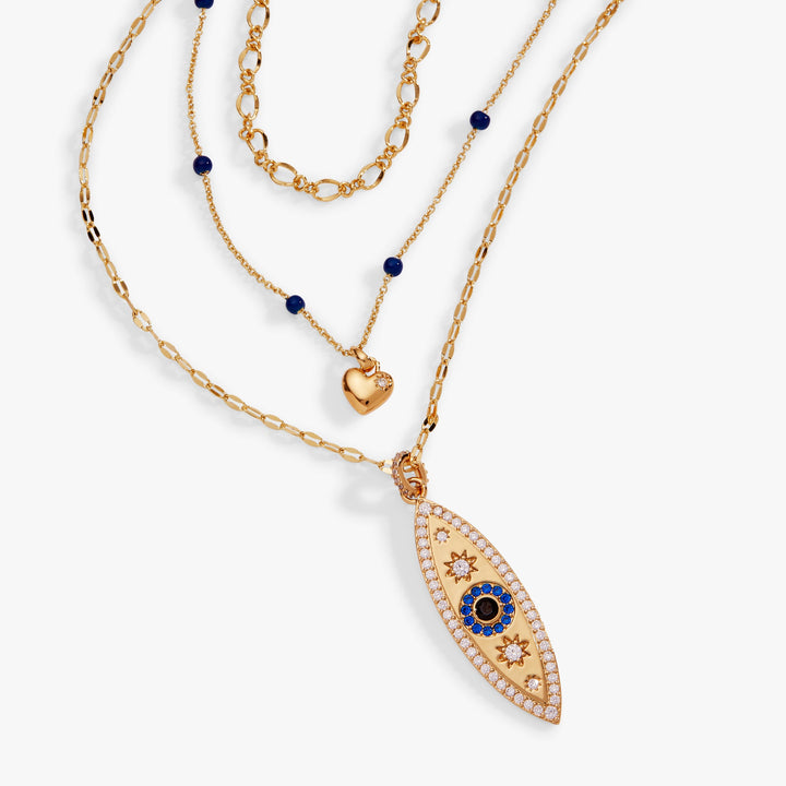 Gold necklace with blue gemstones on a white background