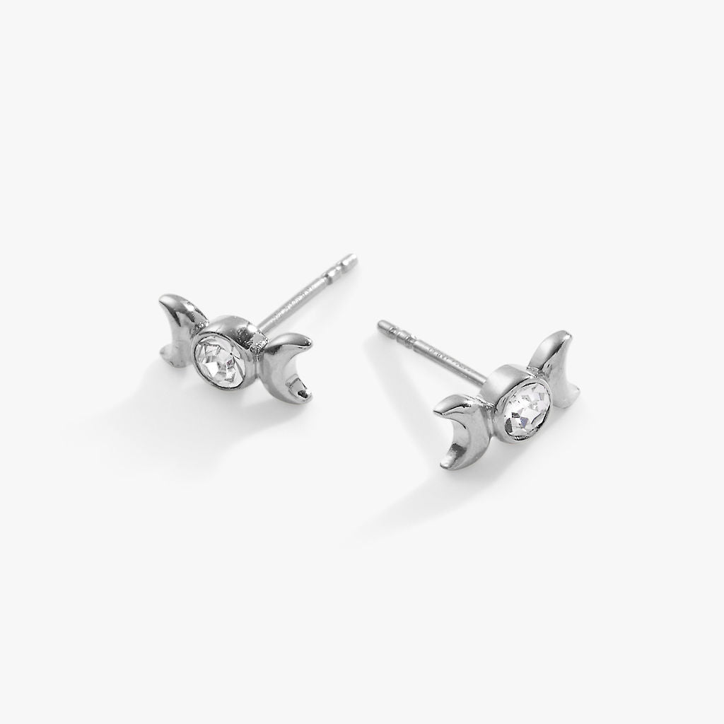 Silver earrings with small diamonds on a white background