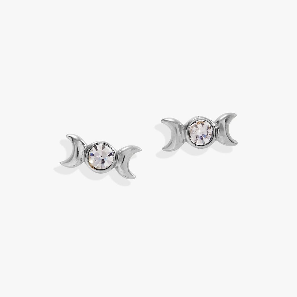 Pair of silver triple goddess earrings with crystal elements on a white background