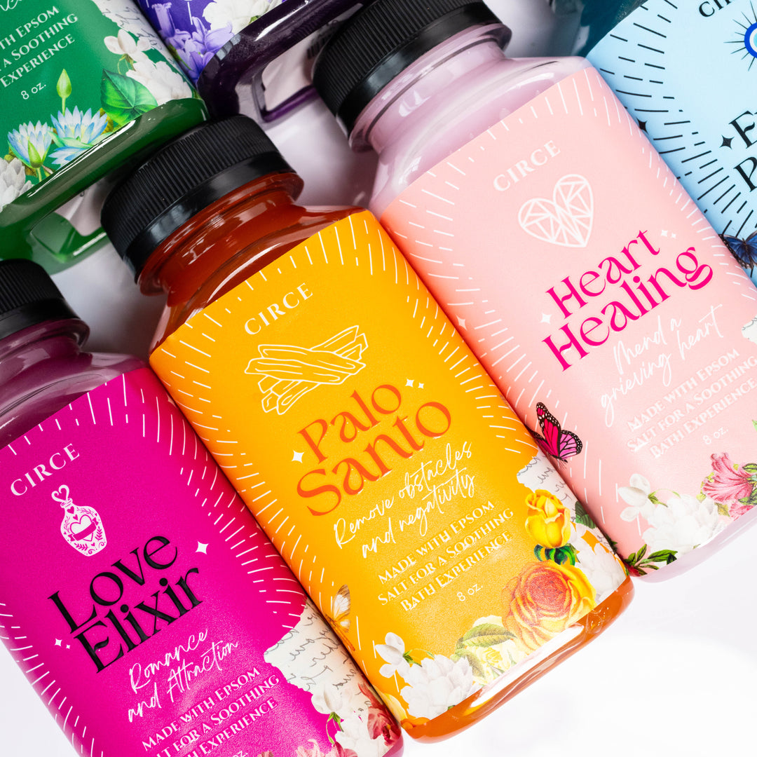 Bottles of Circe products including 'Love Elixir' and 'Palo Santo' on a white background
