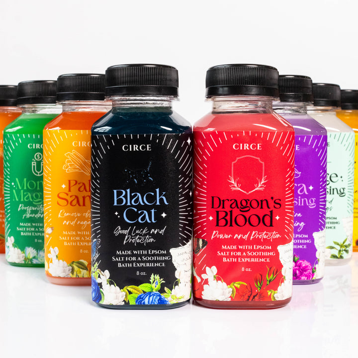 Row of Circe bath salt bottles with colorful labels on a white background